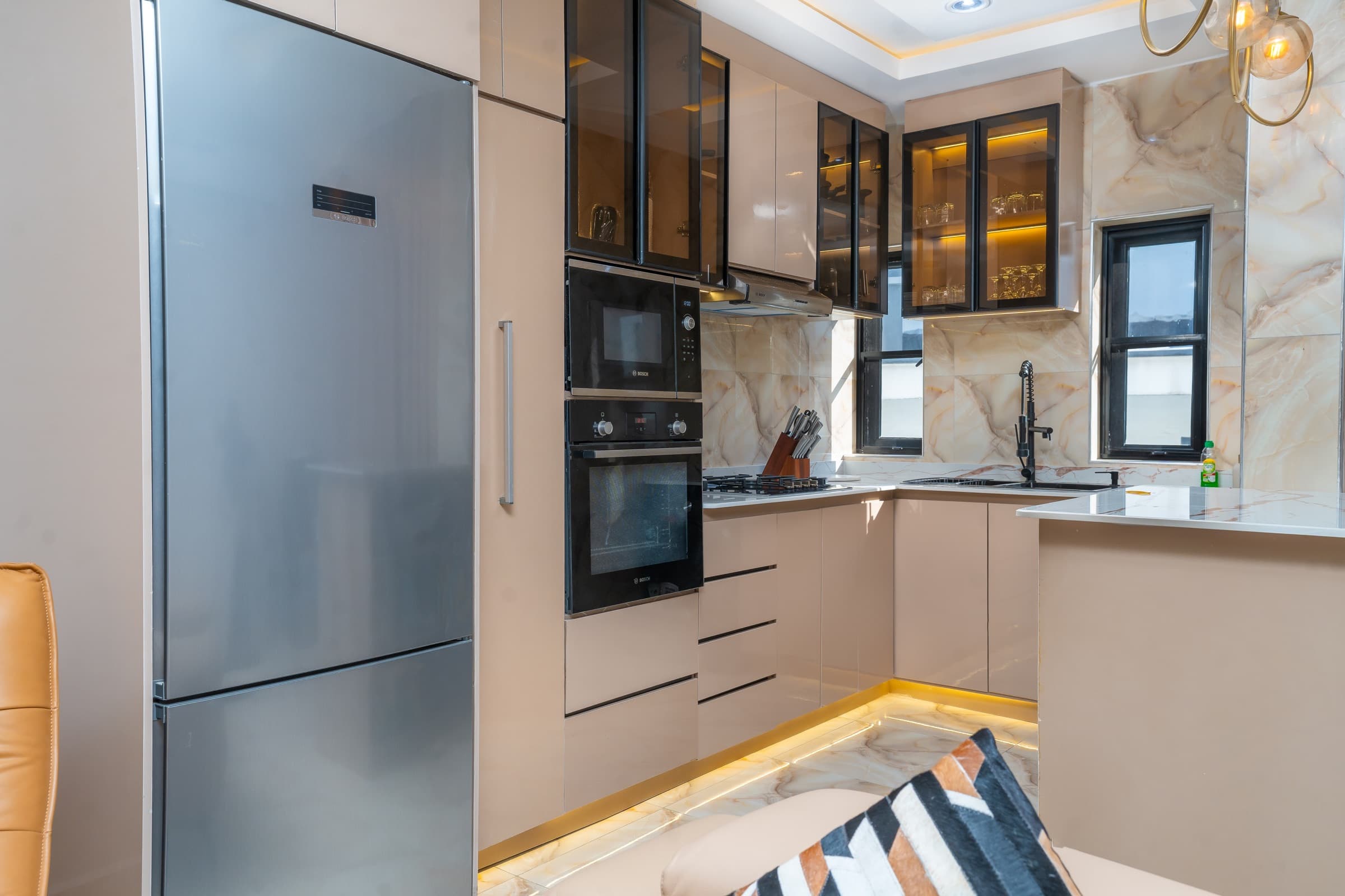Modern fitted kitchen with built-in oven and microwave