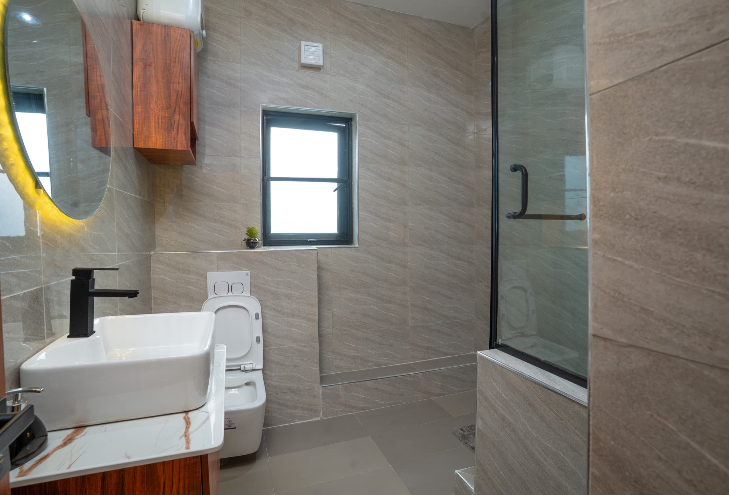 En-suite bathroom with vessel sink and glass shower